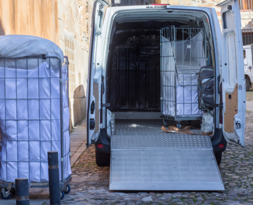 Picking,Dirt,Laundry,Carts.,The,Van,Equipped,With,Lift,Ramp