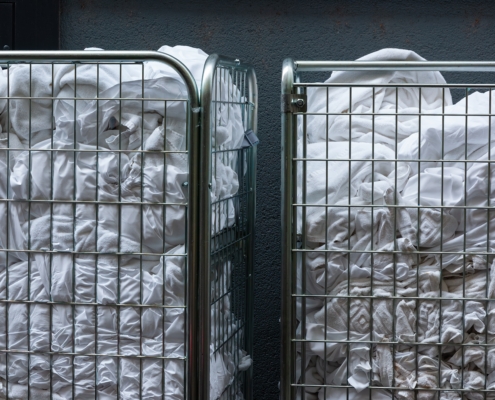 Strollers,With,Dirty,White,Bed,Linen,And,Towels,In,Front